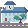 A two story building with a clock tower. It has a flag and tree as well. There is a road in front of it