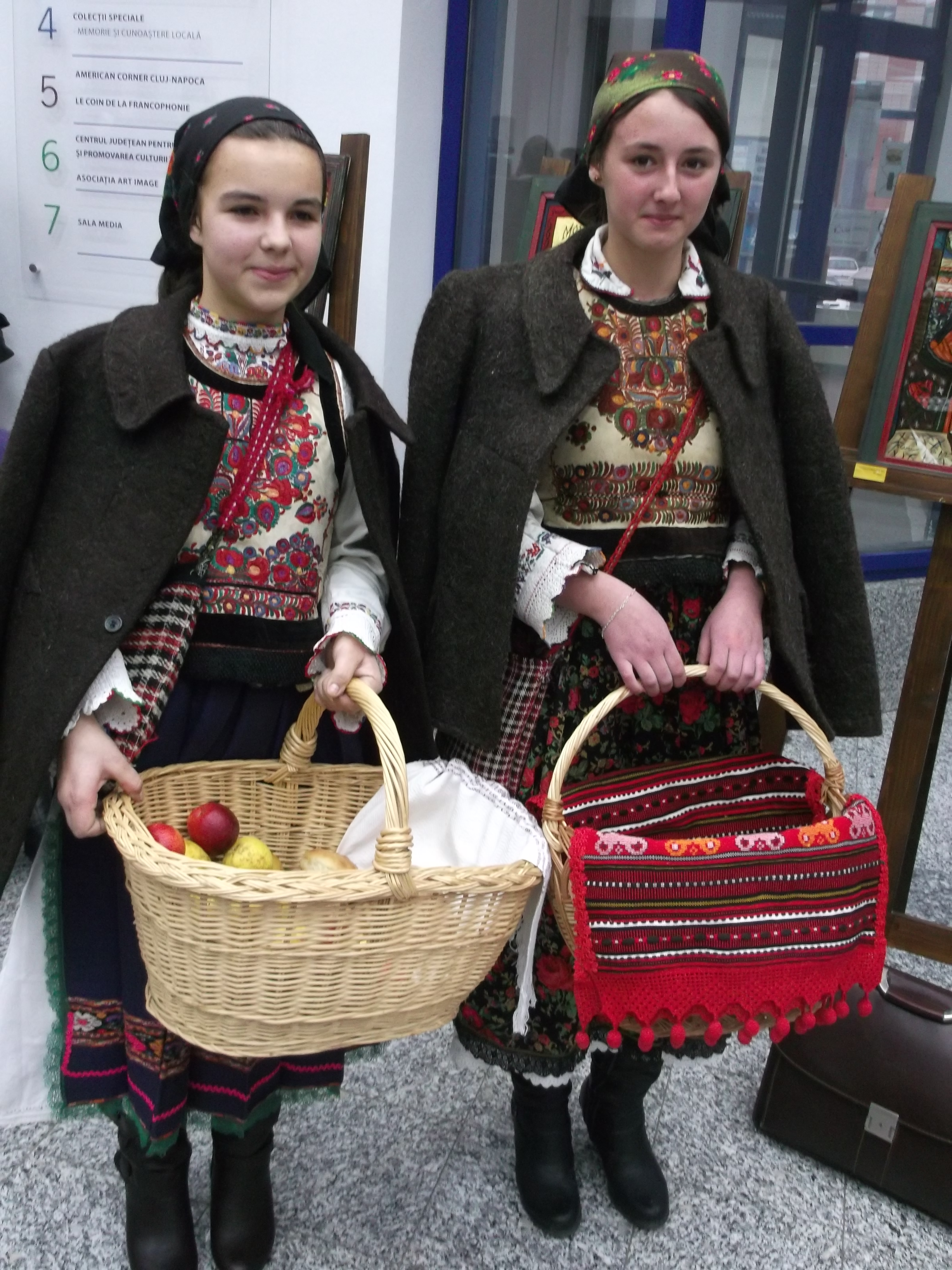 two girls wearing the cloak, dress, and apron of Transylvania.