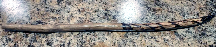 a wooden wand with woodburnt designs
